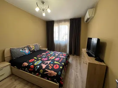 a bedroom with a bed and a flat screen tv at Johannesburg 2BDR Spacious Family apt w Parking and Playground in Sofia