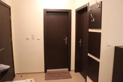 a bathroom with two black doors in a room at Apartment in Forest Glade Hotel in Pamporovo