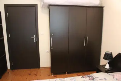 two black cabinets in a bedroom with a bed at Apartment in Forest Glade Hotel in Pamporovo