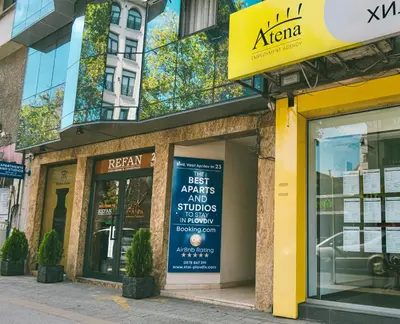 a store with a sign on the front of a building at Cityscape Luxury Suites in Plovdiv