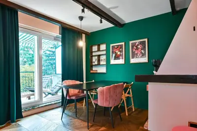 a dining room with green walls and a table and chairs at Lozenetz Gem Cozy 1-Bedroom Apartment in Sofia by Flat Mаnager in Sofia