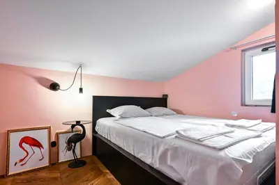 a pink bedroom with a bed and a window at Lozenetz Gem Cozy 1-Bedroom Apartment in Sofia by Flat Mаnager in Sofia