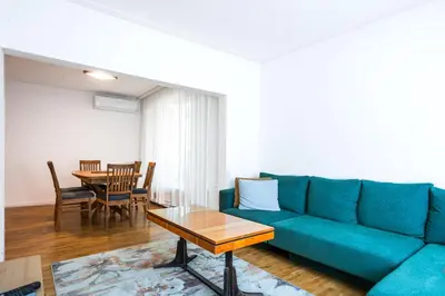 a living room with a blue couch and a table at Contemporary Comfort 1BD Flat in Lozenetz, Sofia by Flat Mаnager in Sofia