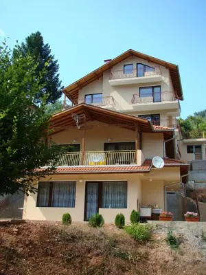 an apartment building with balconies on a hill at Villa Shipkovo in Shipkovo