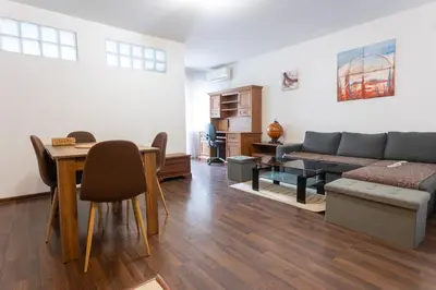 a living room with a couch and a table at Karastoyanovi's apartment 3 in Sofia