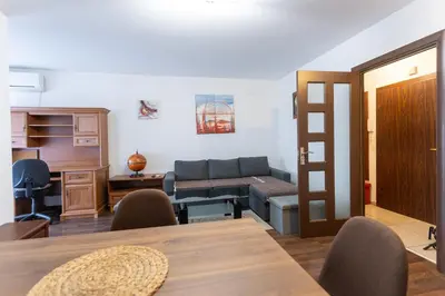 a living room with a couch and a table at Karastoyanovi's apartment 3 in Sofia