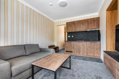 a living room with a couch and a table at Къща за гости Чудните Мостове in Zabŭrdo