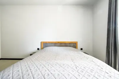 a bed in a bedroom with a white mattress at 6 Studios 6 Bathrooms 2 Levels Kitchens in Sofia