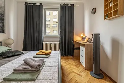 a bedroom with two beds and a desk and a window at Vivid Condo by NDK and Vitosha Blvd with Free Secured Parking and AC in Sofia