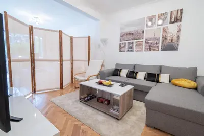 a living room with a couch and a table at Vivid Condo by NDK and Vitosha Blvd with Free Secured Parking and AC in Sofia