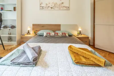 a bedroom with a large bed with towels on it at Vivid Condo by NDK and Vitosha Blvd with Free Secured Parking and AC in Sofia