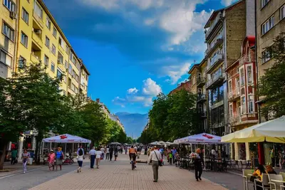 a group of people walking down a city street at 5 Seconds Away from the Main Street, FREE Secured Parking in Sofia