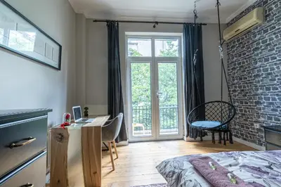 a bedroom with a bed and a desk and a window at 5 Seconds Away from the Main Street, FREE Secured Parking in Sofia