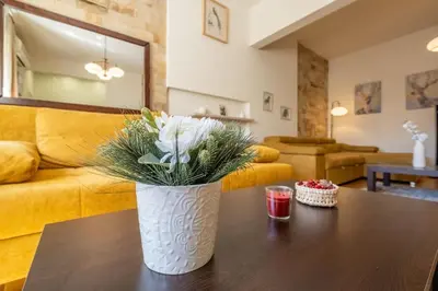 a vase with flowers on a table in a living room at Aristocratic Place, TOP location in Sofia