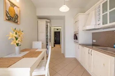 a kitchen with white cabinets and a counter top at Aristocratic Place, TOP location in Sofia