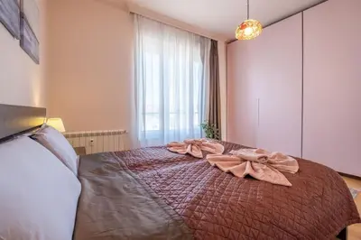 a bedroom with a large bed with a bow on it at Aristocratic Place, TOP location in Sofia