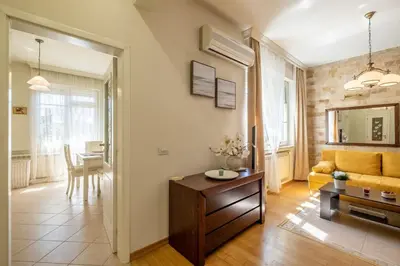 a living room with a couch and a table at Aristocratic Place, TOP location in Sofia
