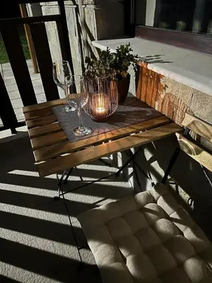 a wooden table with wine glasses and a potted plant at Cozy Riverside Pine Studio E5 in Borovets