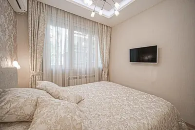 a bedroom with a bed and a tv on the wall at Cappuccino Dream in Sofia