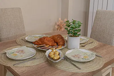 a wooden table with plates of food on it at Cappuccino Dream in Sofia