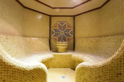 a tiled bathroom with a toilet in the middle at Forest view in Pamporovo