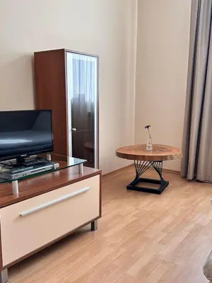 a living room with a table and a coffee table at Spacious studio sleeps 4 in Flora main building 706A in Borovets