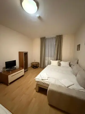 a bedroom with a large white bed and a television at Spacious studio sleeps 4 in Flora main building 706A in Borovets