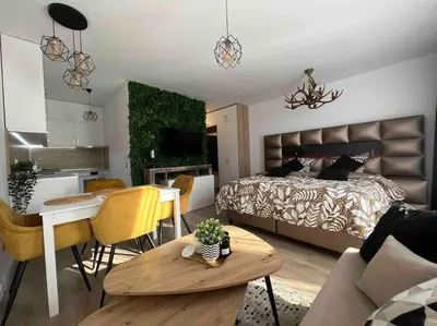 a bedroom with a bed and a living room at Cosy Appartement Green Life Bansko in Bansko
