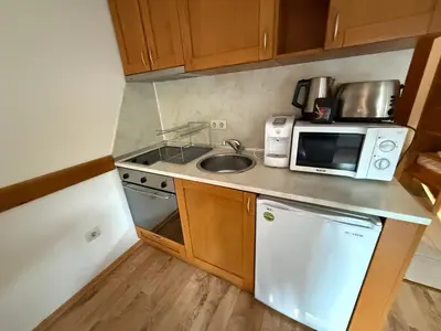 a small kitchen with a sink and a microwave at Studio Royal Plaza sleeps 4 Prime location, distance to ski lift - 50M in Borovets