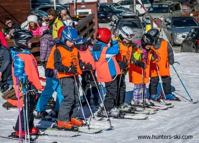 a group of children on skis in the snow at Studio Royal Plaza sleeps 4 Prime location, distance to ski lift - 50M in Borovets