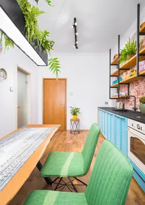 a living room with green chairs and a table at Alexandra's City Center Apartment II in Sofia