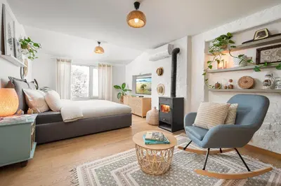 a living room with a couch and a fireplace at Alexandra's City Center Apartment III in Sofia