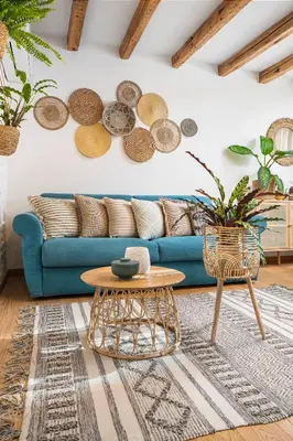a living room with a blue couch and a table at Alexandra's City Center Apartment III in Sofia