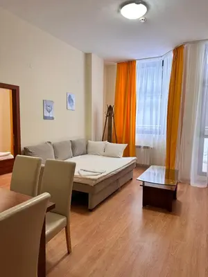 a living room with a couch and a table at Stylish one bedroomed apartment 112 in main Flora building in Borovets