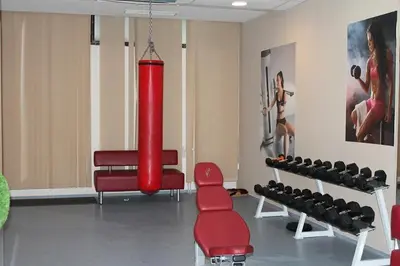 a room with a gym with a large red punching at Stylish one bedroomed apartment 112 in main Flora building in Borovets