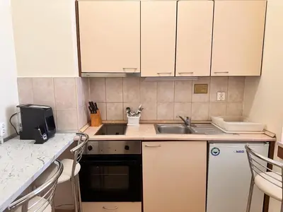 a kitchen with white cabinets and a sink at Stylish one bedroomed apartment 112 in main Flora building in Borovets