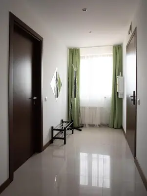 a hallway with a door and a window with green curtains at Pirin Bliss Apartment Ski, Spa and Relax at Terra Complex in Razlog