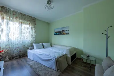 a bedroom with a bed and a couch at Julie Suite Top Center in Sofia