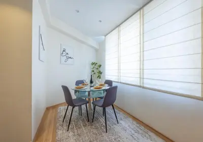 a dining room with a glass table and chairs at Julie Suite Top Center in Sofia