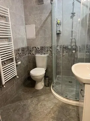 a bathroom with a toilet and a shower and a sink at Nice new apartment in Sofia