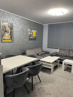 a living room with two tables and a couch at Nice new apartment in Sofia