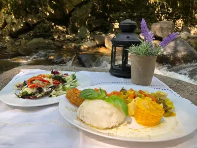 two plates of food are sitting on a table at Стаи за гости в Ритрийт Център 