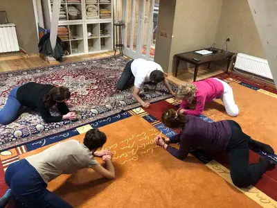 a group of women drawing on a rug at Стаи за гости в Ритрийт Център 