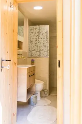 a bathroom with a toilet and a sink at Стаи за гости в Ритрийт Център 