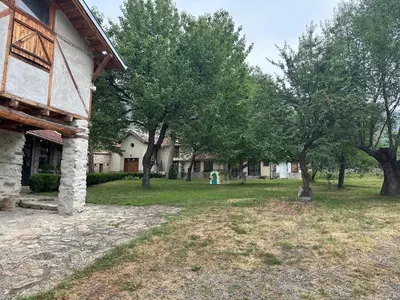 a house with a yard with trees and a building at Подковите in Karlovo