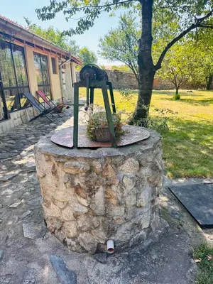 a statue sitting on top of a stone wall at Подковите in Karlovo