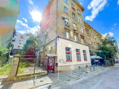 a building on a street with the sun behind it at Sofia's Best Kept Secret in Prime Location! in Sofia