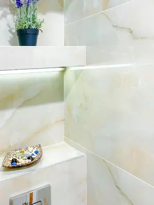 a bathroom with white marble walls and a plate of rocks at Sofia's Best Kept Secret in Prime Location! in Sofia
