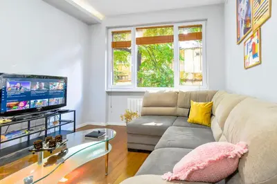 a living room with a couch and a tv at Sofia's Best Kept Secret in Prime Location! in Sofia