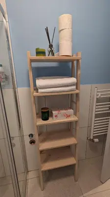 a wooden shelf with towels on it in a bathroom at 65 Duck House in Sofia